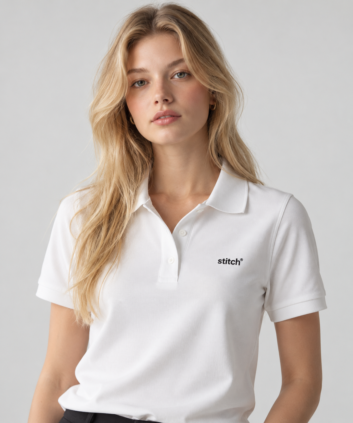 Model wearing a white Stitch polo